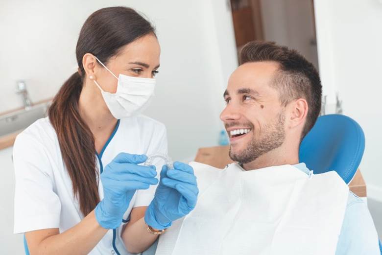 dentist showing a patient how Invisalign works