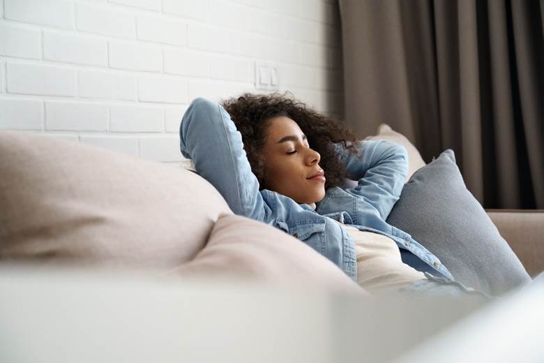 Woman resting at home during tooth extraction recovery