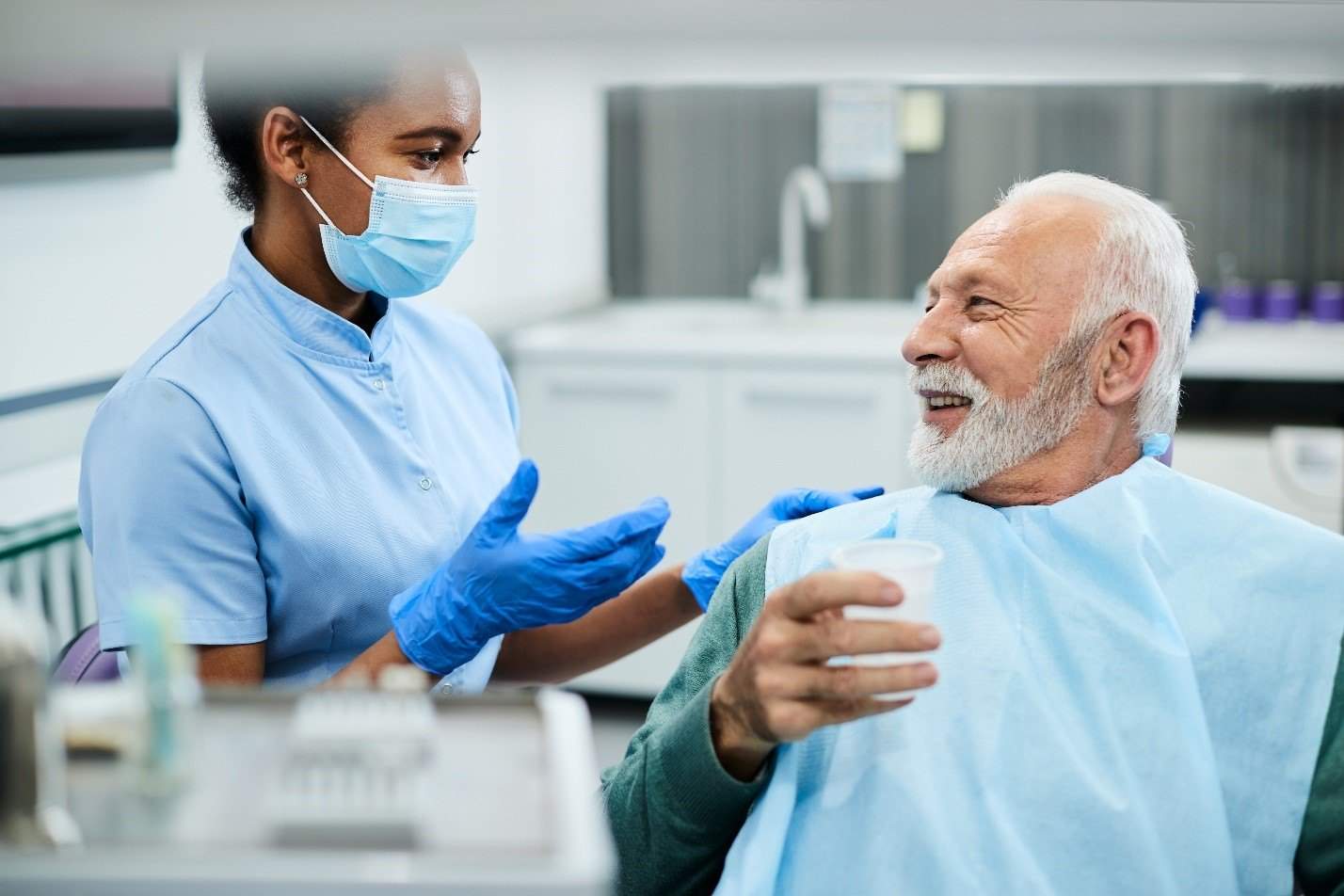 dentist talking to patient about dental crowns in Edmonton