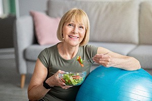woman eating healthy for dental implant care in Edmonton