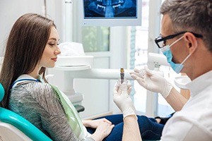 patient learning how dental implants work in Edmonton