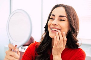 woman smiling about how dental implants work in Edmonton